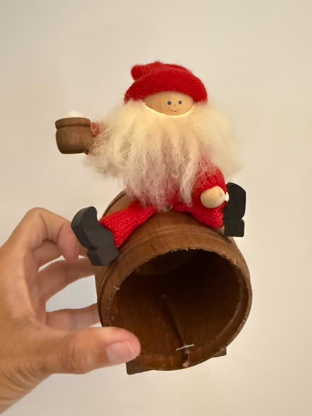 Vintage Wooden Swedish Tomte Gnome Santa sitting on a barrel holding a mug.